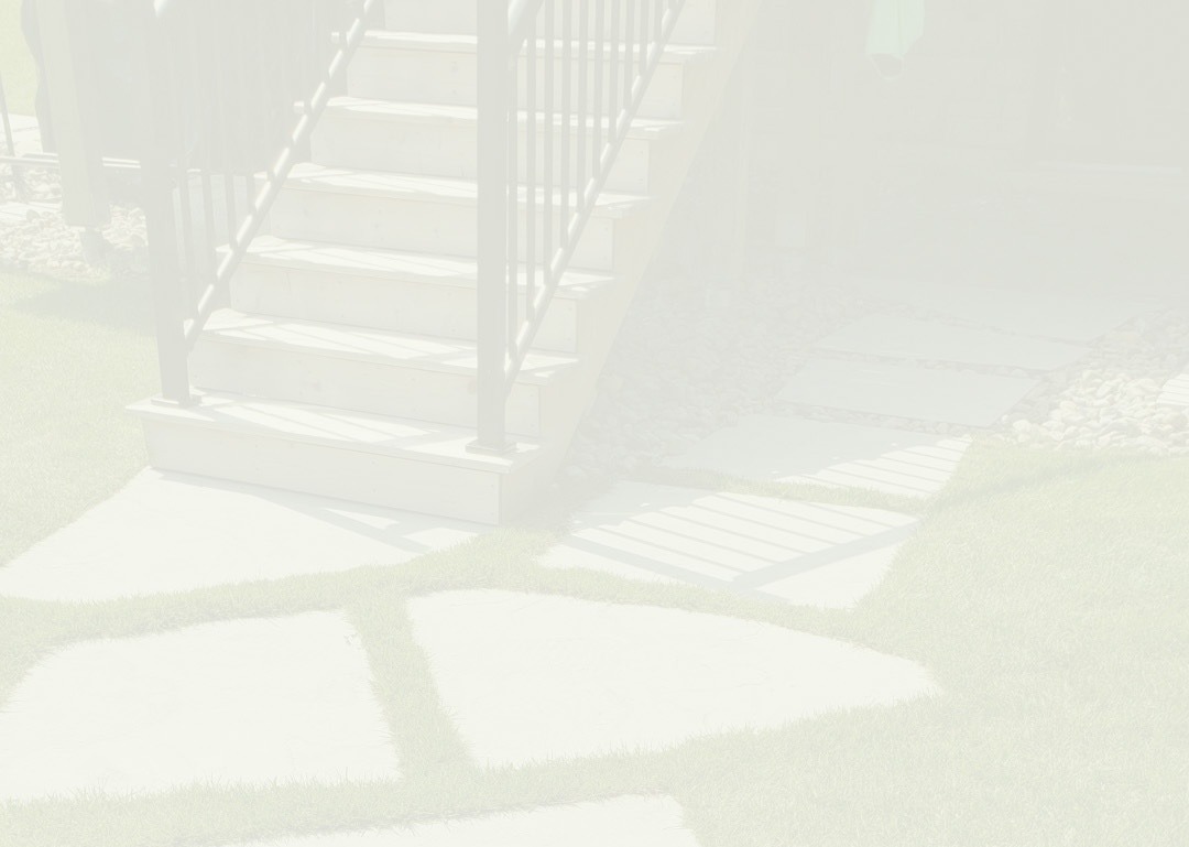 The image is overexposed, showing a faded view of outdoor stairs, stepping stones, a neatly manicured lawn, and part of a metal railing.