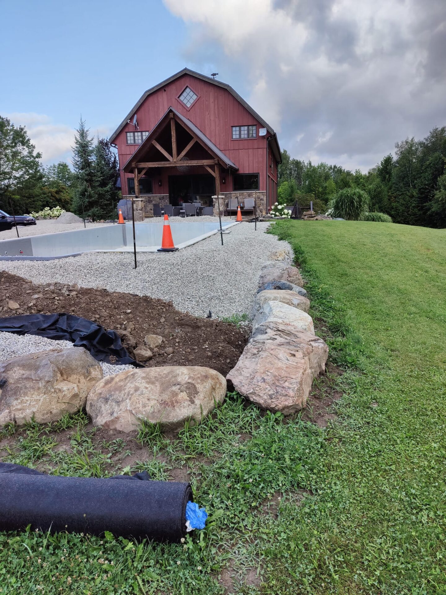 this image shows a pool installation and retaining wall in construction progress