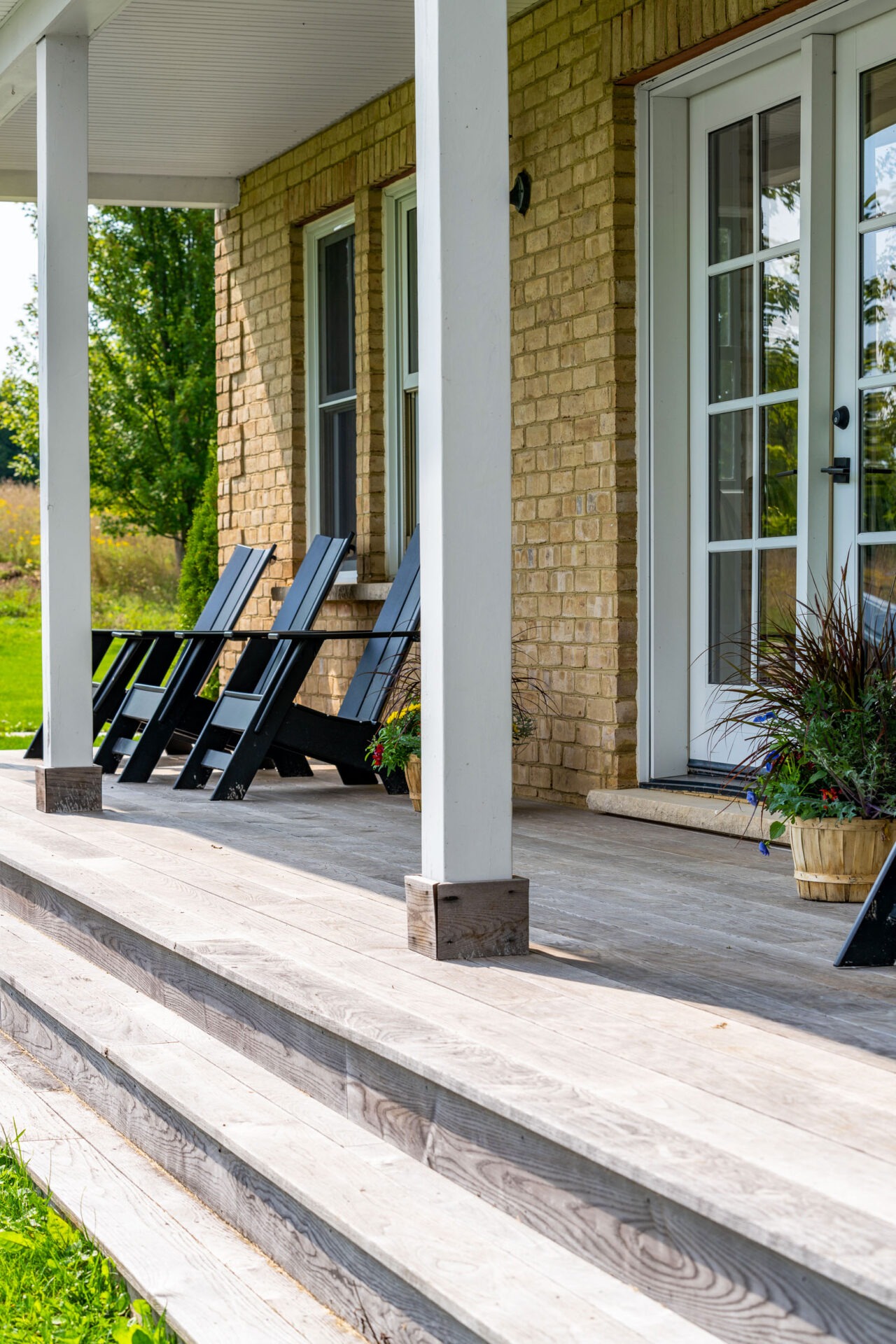 this image shows a brick farmhouse with new Thermory deck