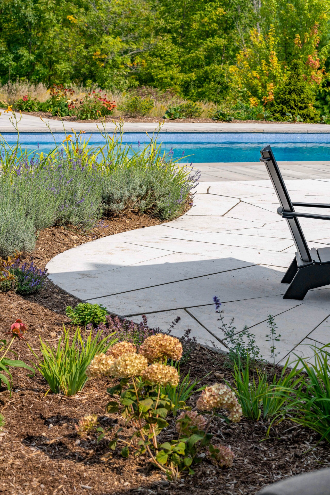 this image shows a flagstone walkway with pollinator garden