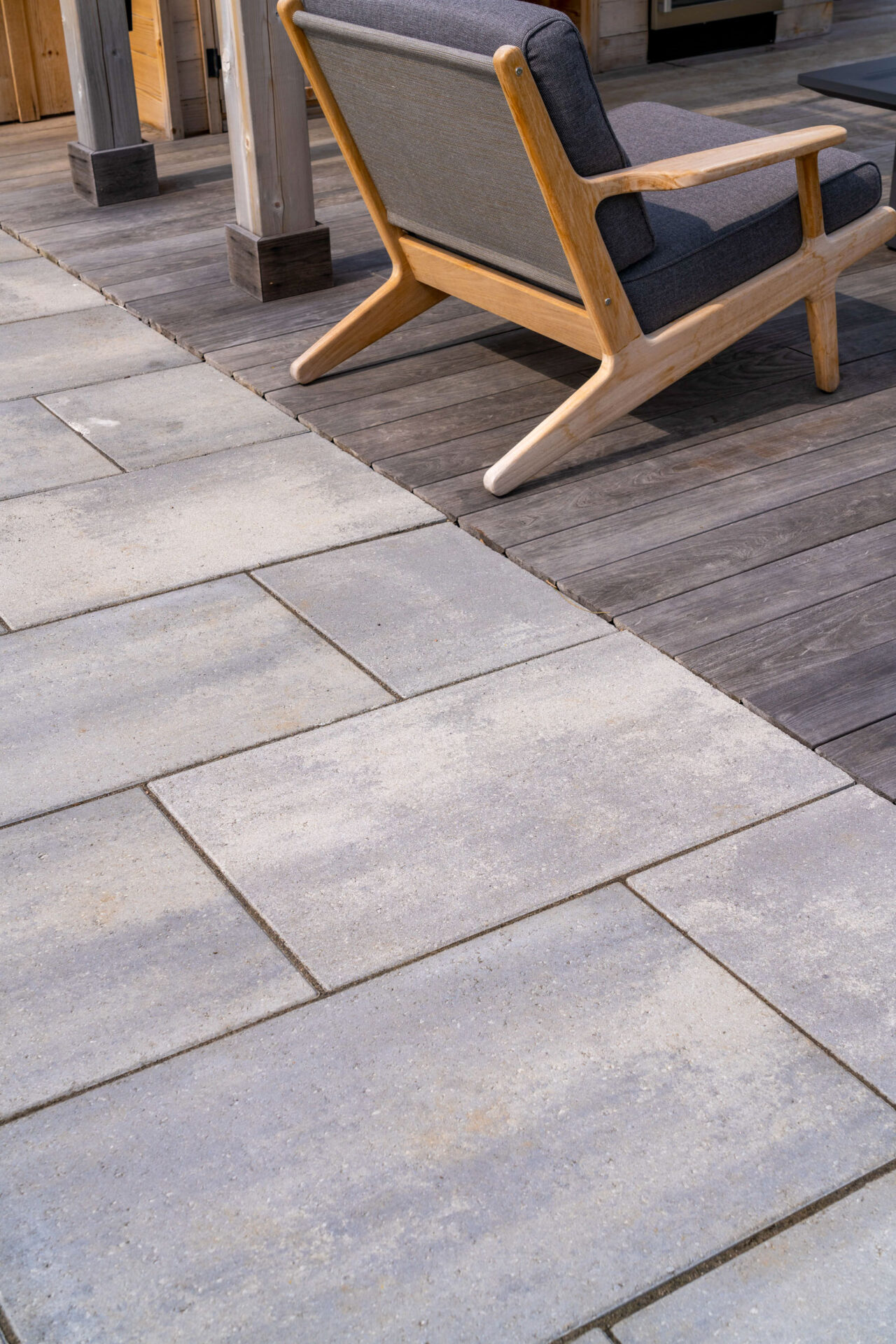 this image shows a close-up transition from paver patio to thermory decking