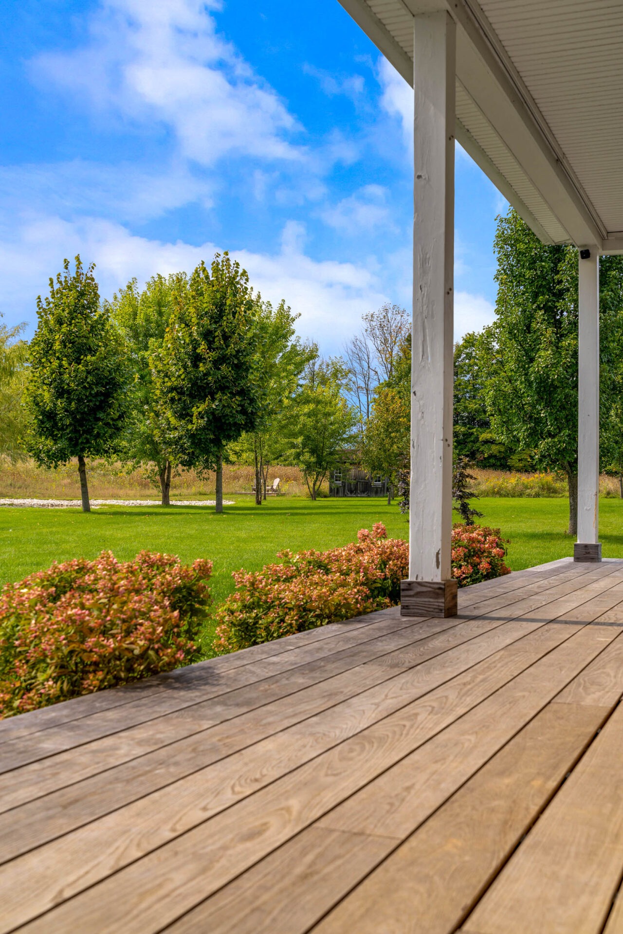 this image shows a new thermory deck in a country landscape